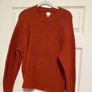 Warm, dark orange sweater